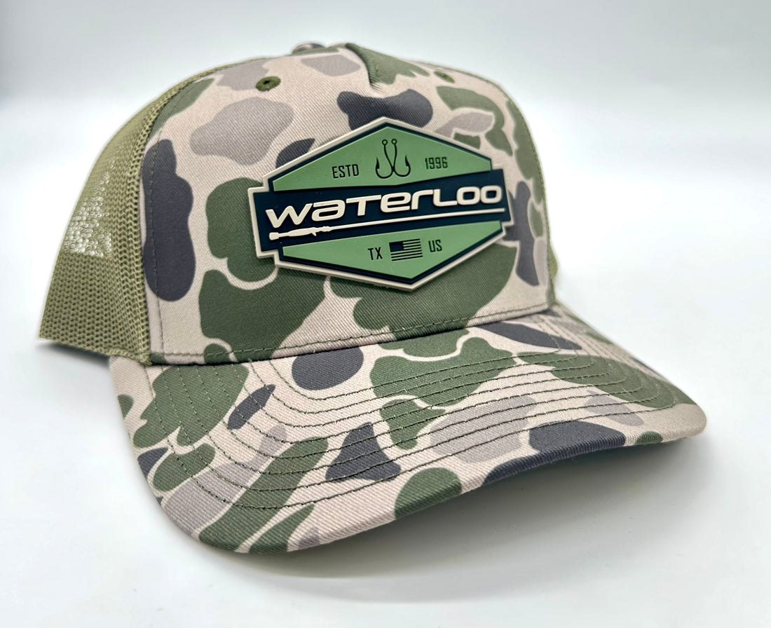 Waterloo Marsh Duck Camo and Loden Cap - Badge Rubber Logo